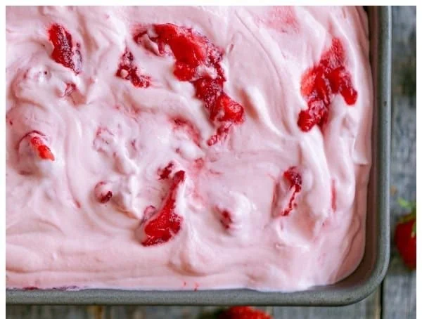 Delicious no churn strawberry ice cream served in a bowl with fresh strawberries