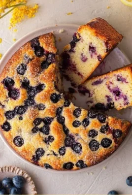 One bowl vegan lemon blueberry cake topped with fresh blueberries and lemon zest