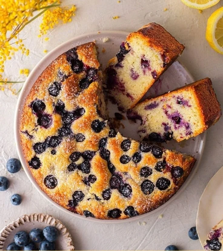 One bowl vegan lemon blueberry cake topped with fresh blueberries and lemon zest