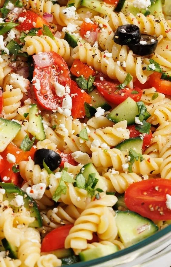 Colorful and tasty pasta salad with vegetables and dressing served in a bowl