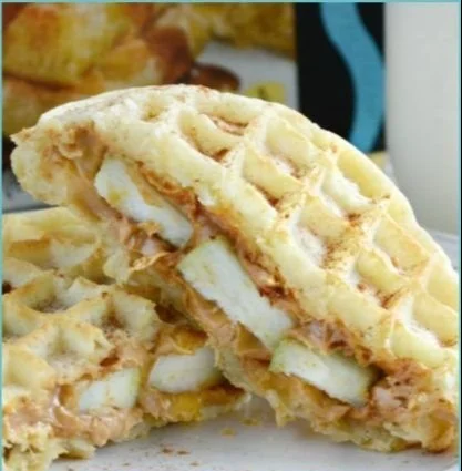Delicious peanut butter apple waffle sandwiches stacked on a plate