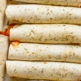 Homemade Pizza Roll Ups with cheese and pepperoni on a plate