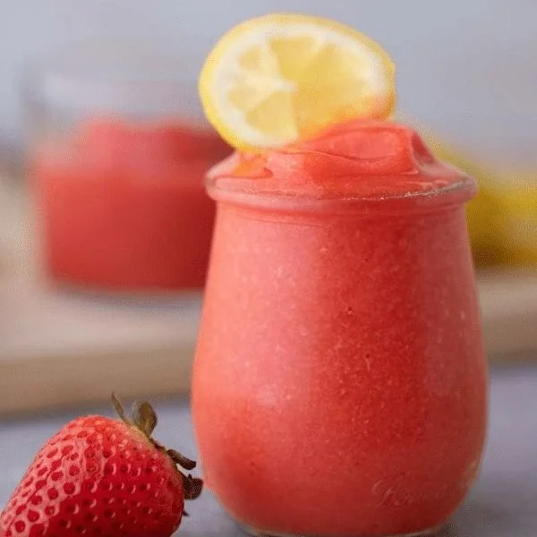 Refreshing frozen strawberry lemonade served in a cup