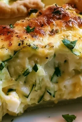 Homemade zucchini pie served on a plate with fresh herbs